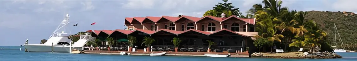 Tropical waterfront resort with yacht and palm trees