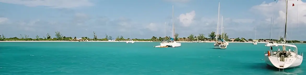 Sailboats anchored in turquoise tropical bay